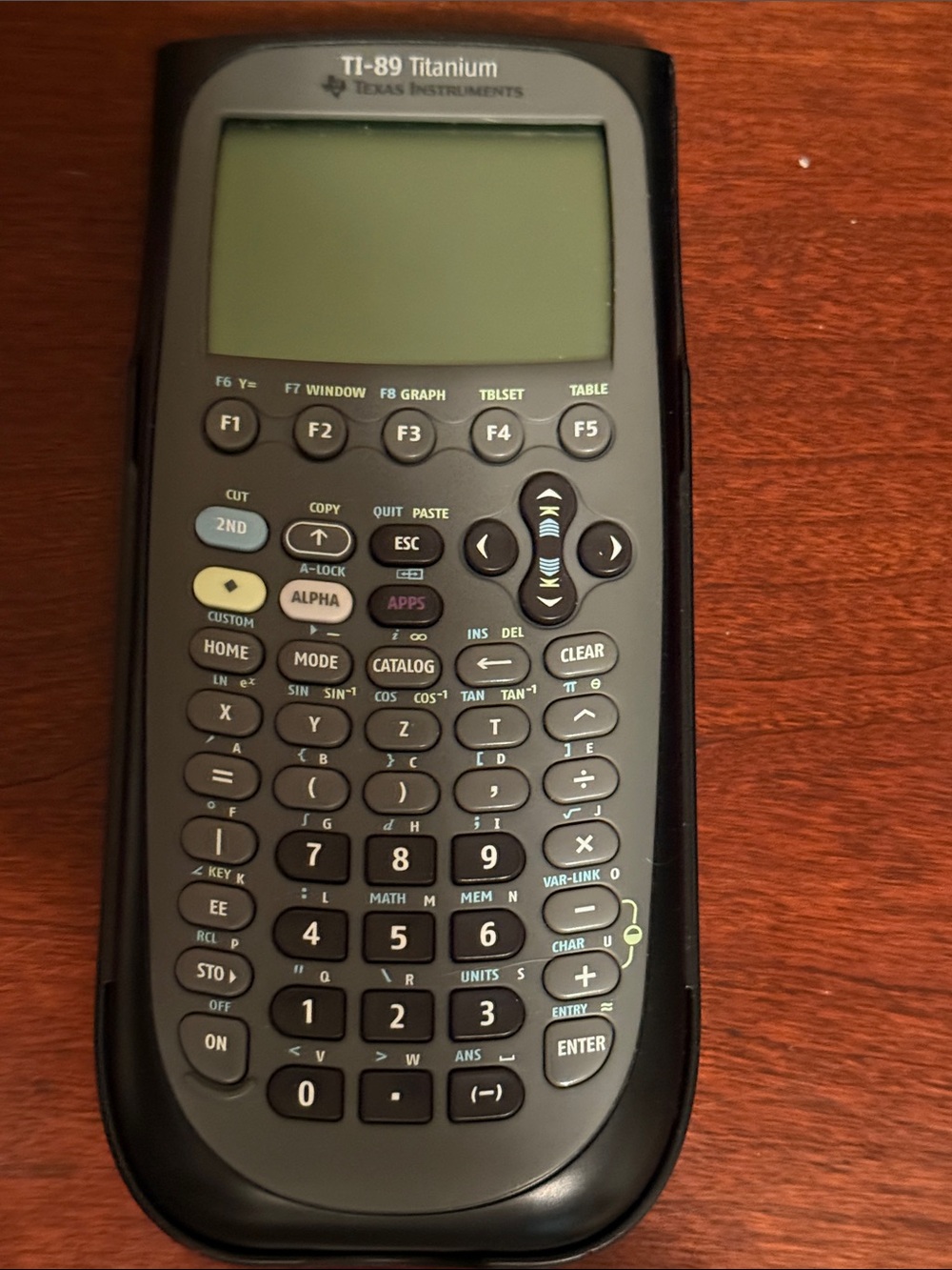 Texas Instruments TI-89 Titanium Calculator with Hardcase shell on the back.